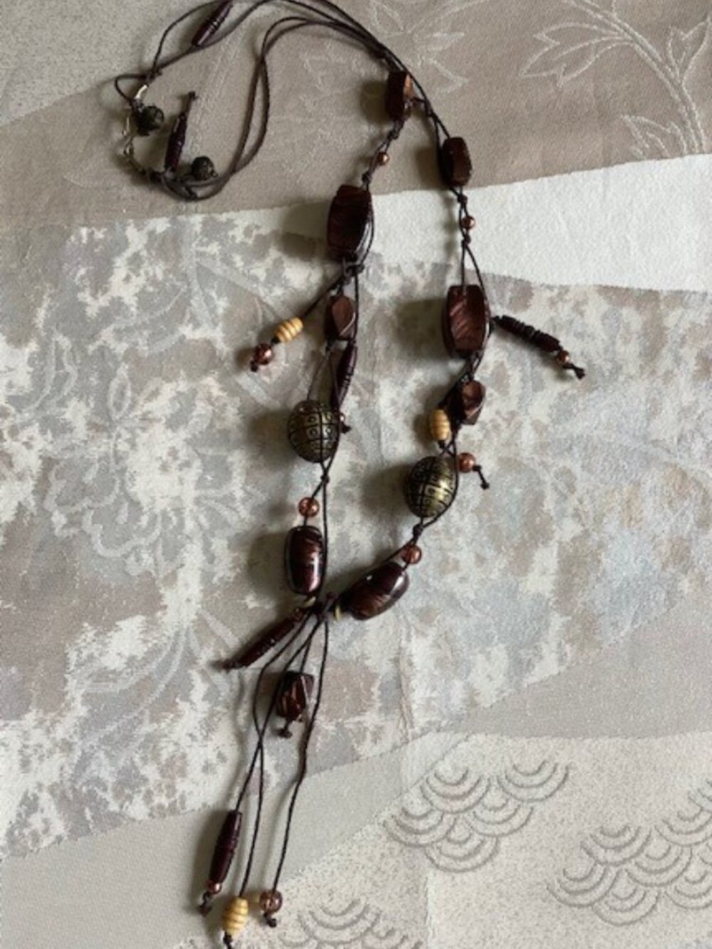 Brown beaded necklace on brown cord, 30 inches